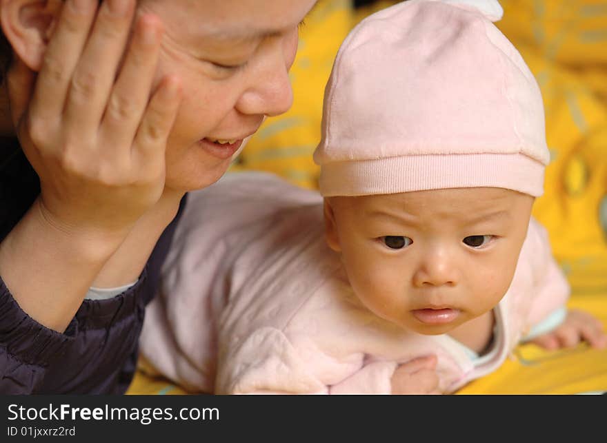 It is a cute chinese baby and his mother. he is 3 months. It is a cute chinese baby and his mother. he is 3 months.