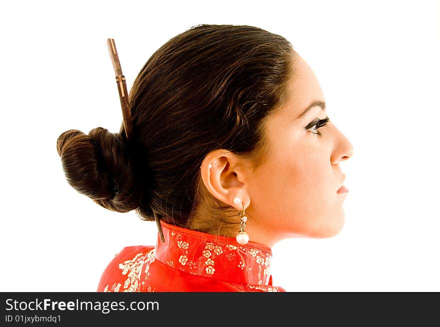 Young female wearing kimono with hair sticks in hair against white background