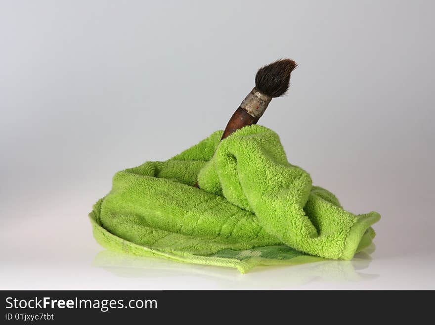 Brush with green towel and blurred background