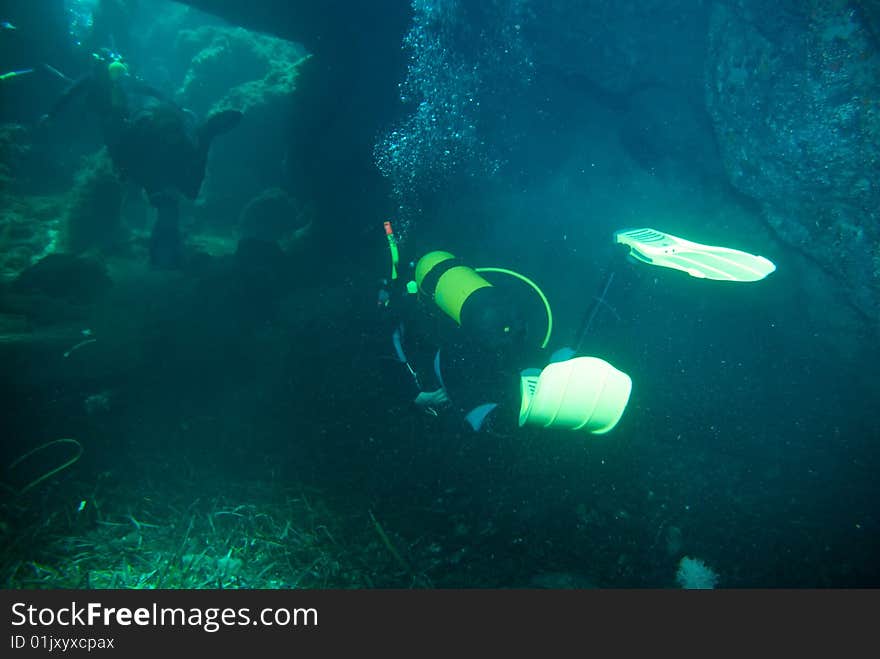 Diver in the mediterranean sea in a cave. Diver in the mediterranean sea in a cave.