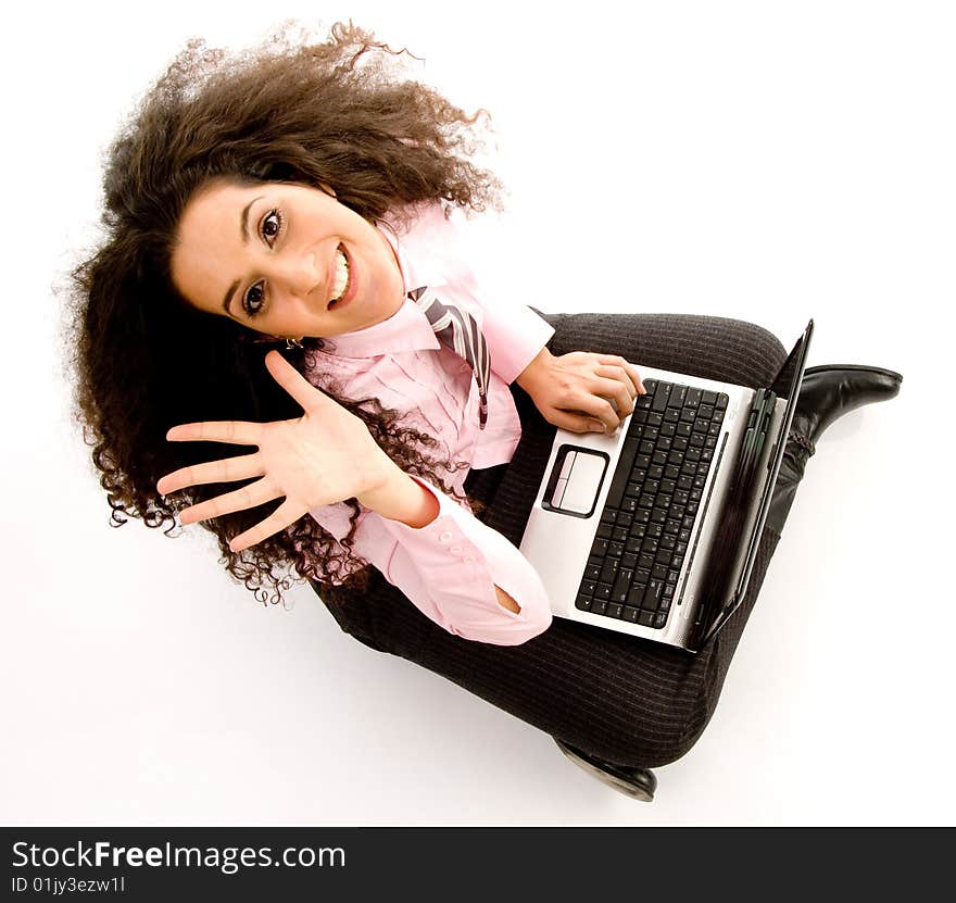 Young hispanic female busy working on laptop on an isolated background