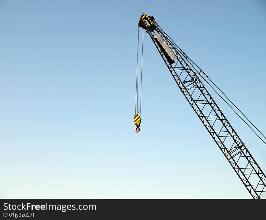 Hook crane with clear, blue sky in background. Hook crane with clear, blue sky in background