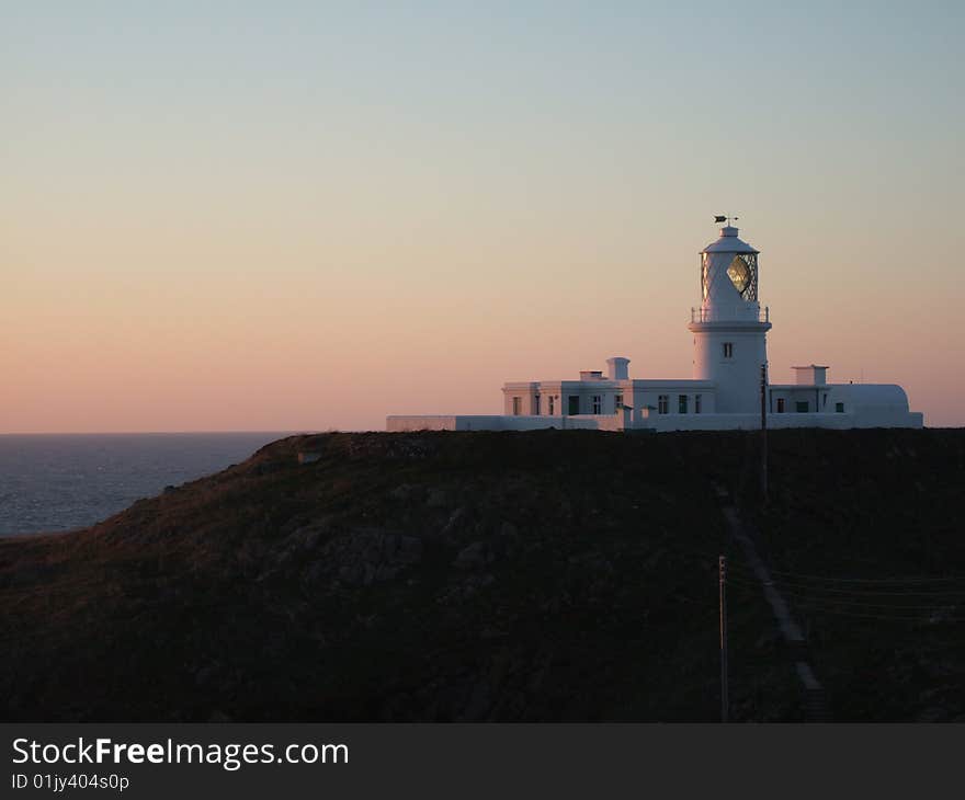 Shot taken of Fishguard Lighthouse taken in the spring at dusk towards Ireland. Shot taken of Fishguard Lighthouse taken in the spring at dusk towards Ireland