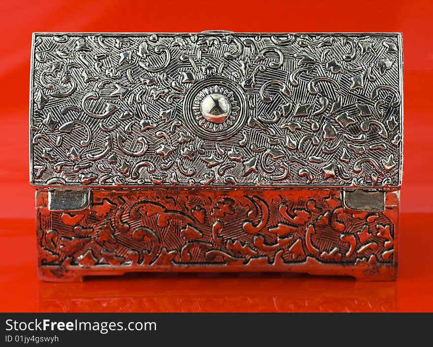 Open silver box isolated on red background. Open silver box isolated on red background