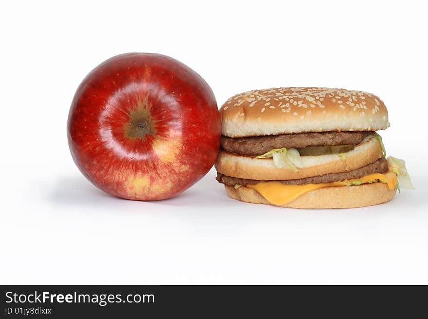 Red apple and hamburger isolated on white background. Red apple and hamburger isolated on white background