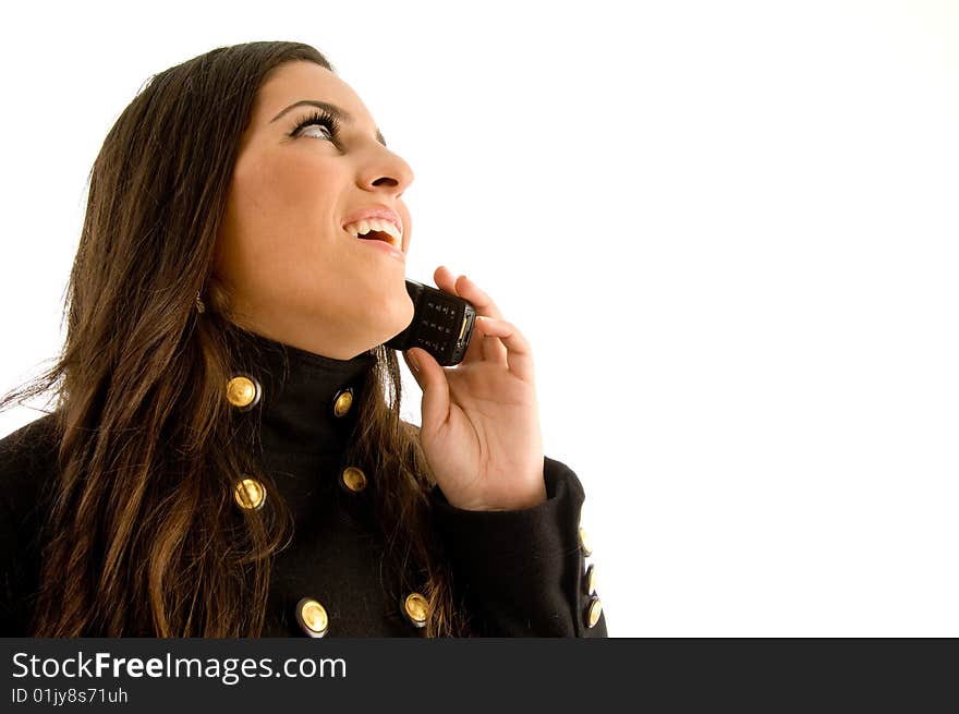 Beautiful model talking on phone against white background