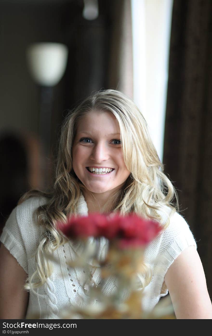 Blond Teen behind flowers