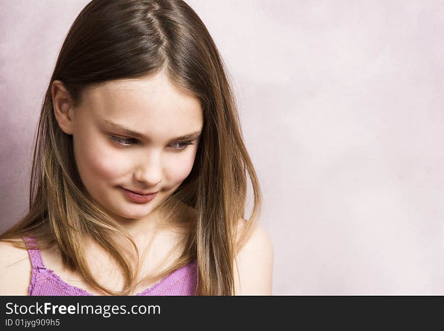 Beautiful young brunette against a pink background. Beautiful young brunette against a pink background