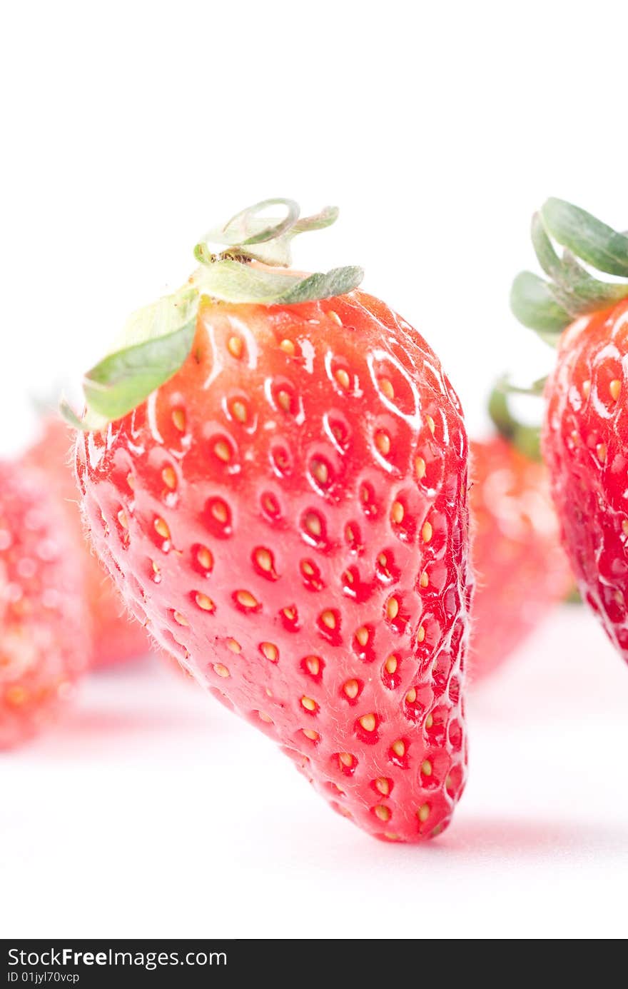 Fresh juicy standing strawberry isolated on white