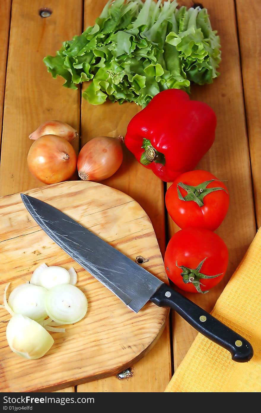 The prepared fresh vegetables for salad on a wooden table