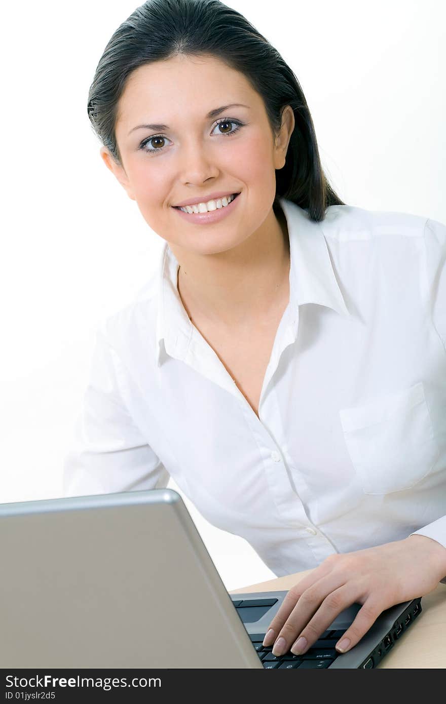 Portrait of beautiful secretary while typing on the laptop