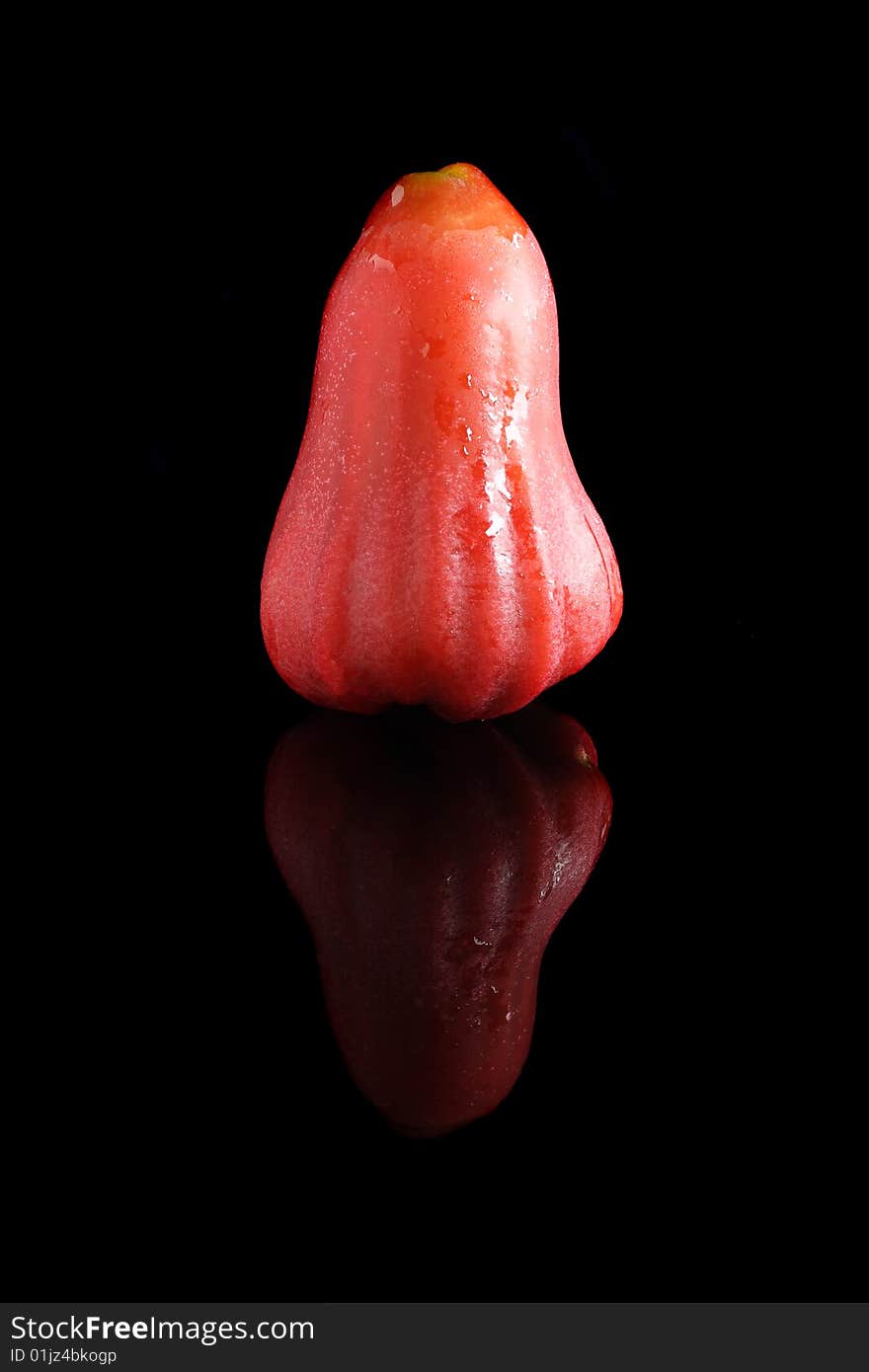 A water apple isolated on black background.