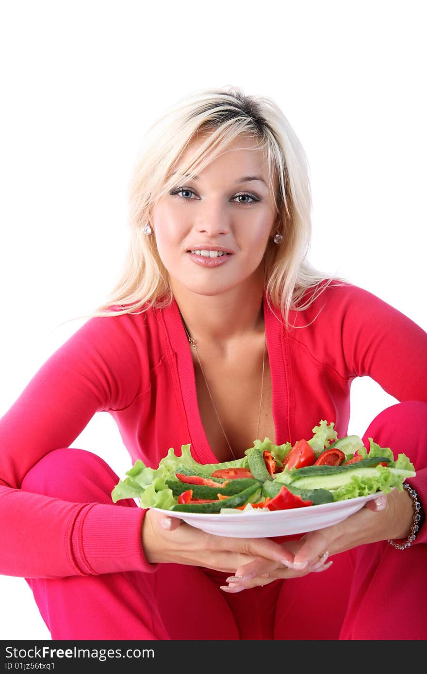 Girl in sport outfit with salad isolated on white. Girl in sport outfit with salad isolated on white