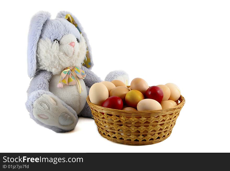 Easter bunny and easter eggs in basket on white background. Easter bunny and easter eggs in basket on white background