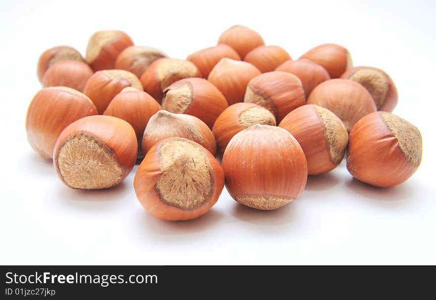 Hazelnuts over the white background