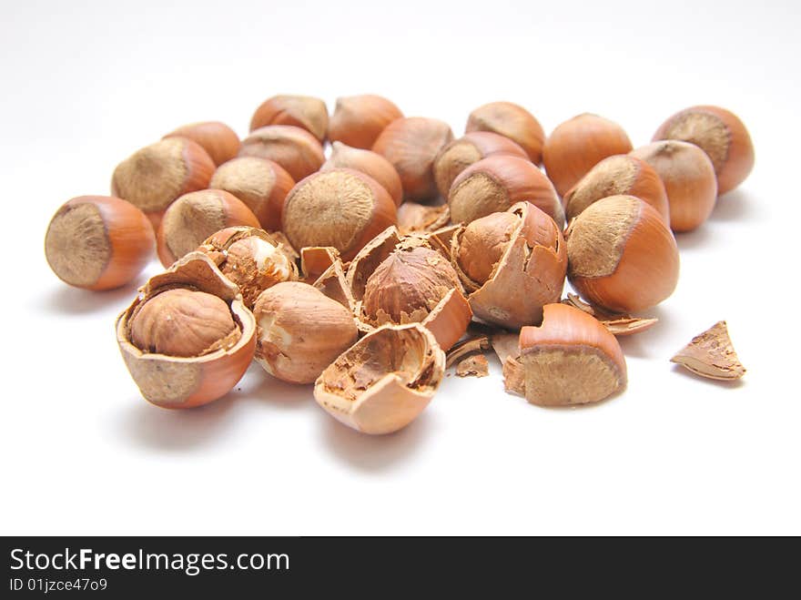 Hazelnuts over the white background