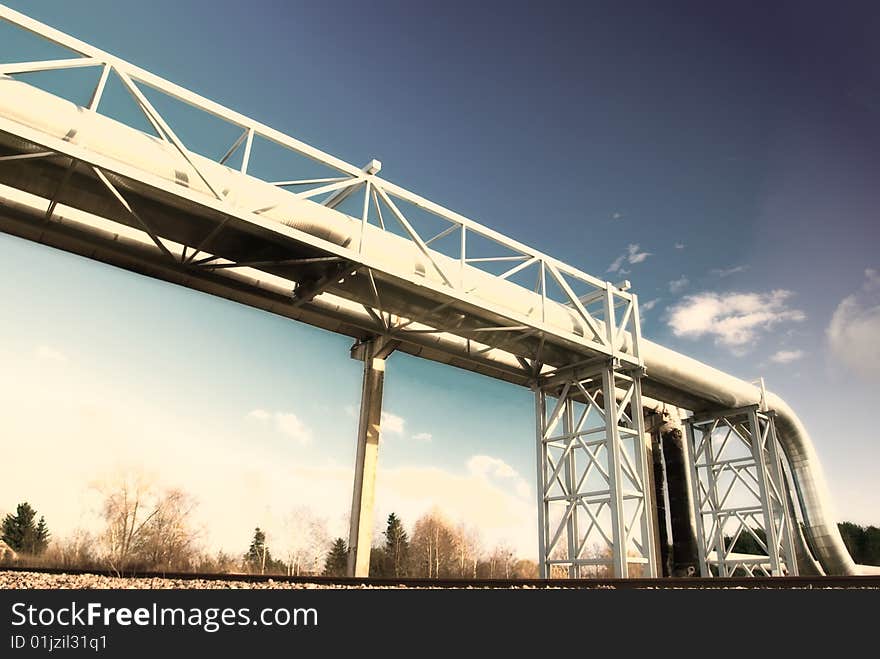 Metallic pipeline over blue sky. Metallic pipeline over blue sky