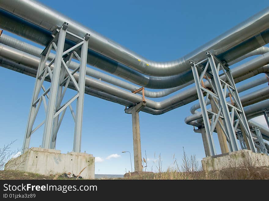 Industrial pipelines against blue sky