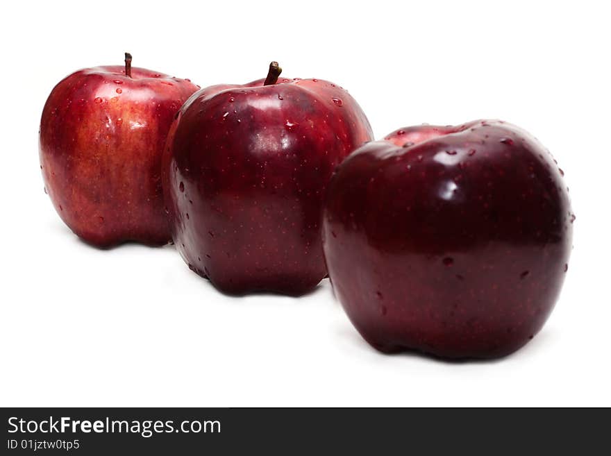 Three red apples, in droplet grow insulated on white background