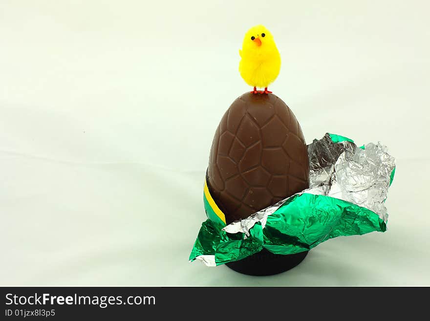 Close-up of easter chocolate egg  with yellow chicken. Close-up of easter chocolate egg  with yellow chicken