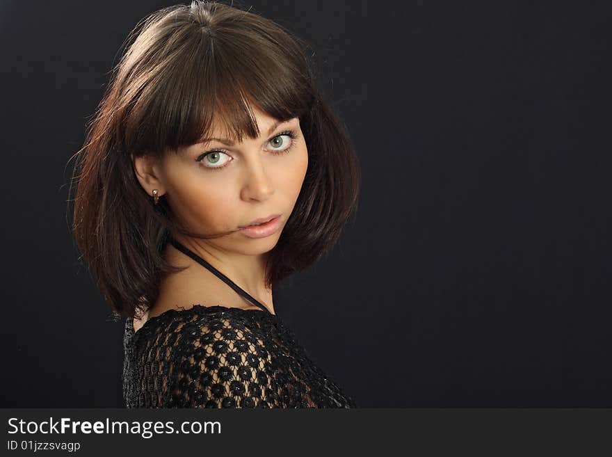 Young beautiful woman on black background