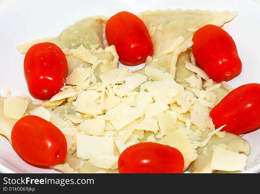 Stuffed ravioli pasta with parmesan and tomato. Stuffed ravioli pasta with parmesan and tomato