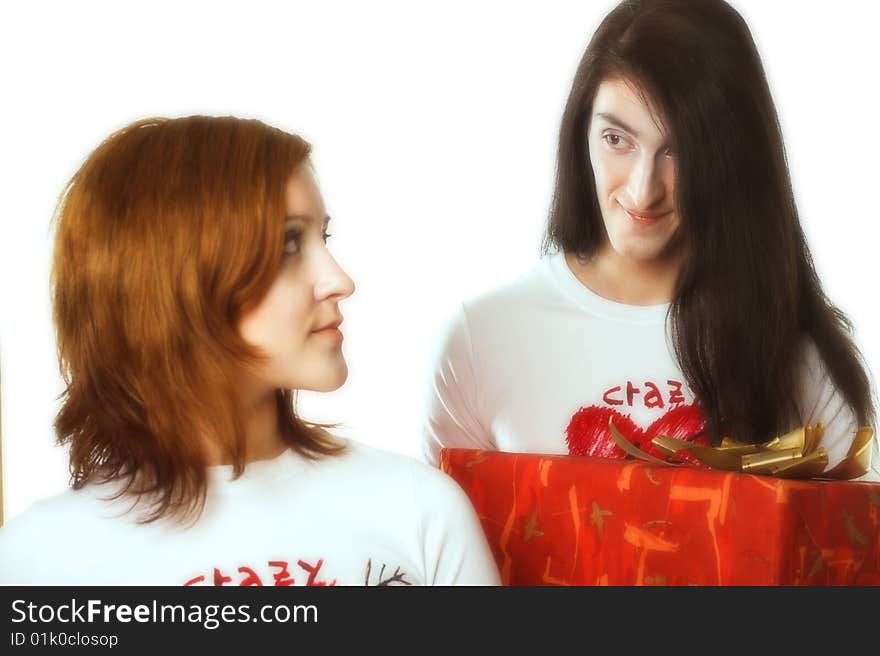 Young happy couple with big red present box.