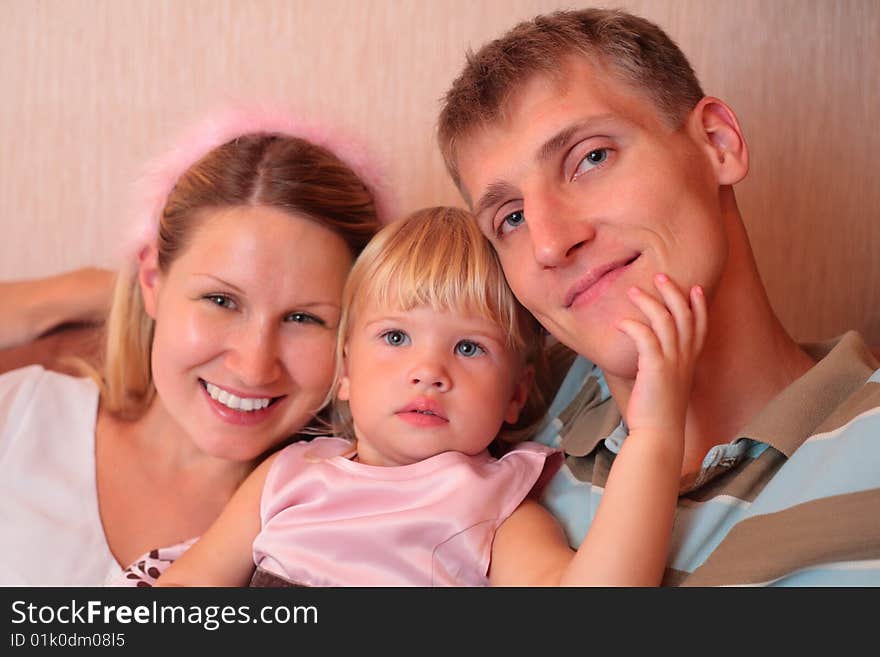 Happy family with little girl in home