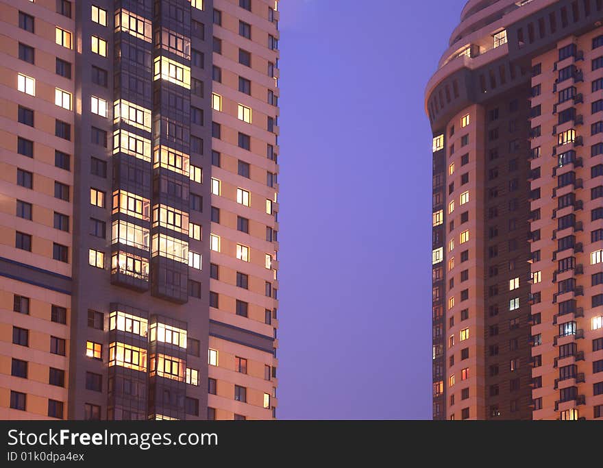 Two apartment houses in evening, fragment