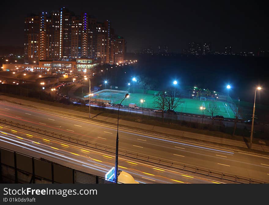 Night street, stadium, houses witn lights