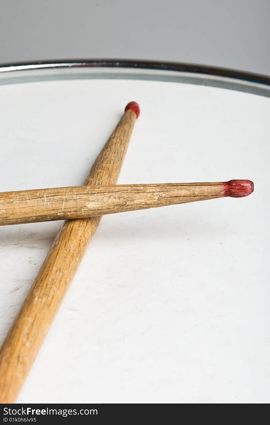 Close up of old wood drumsticks on a drum,check also