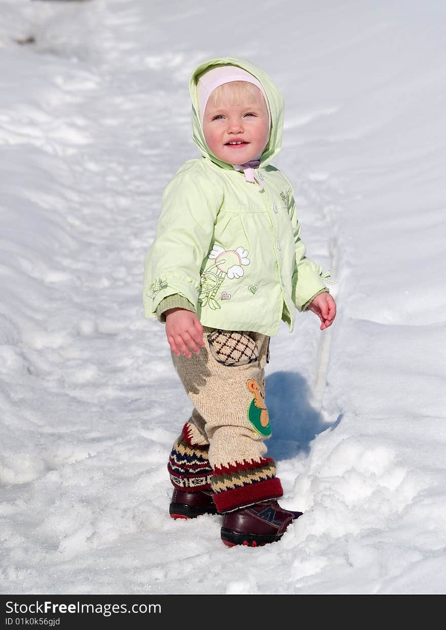 Cute child stands on snow