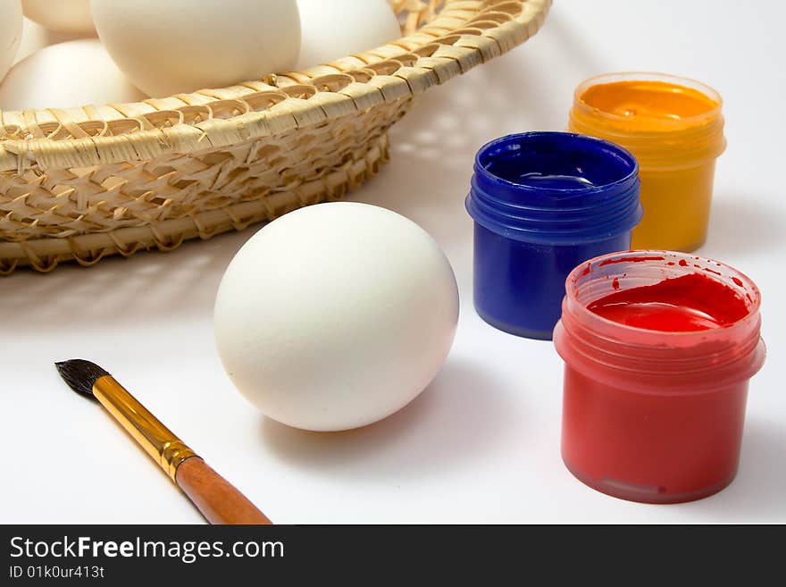 Eggs and paints, preparation for easter on white