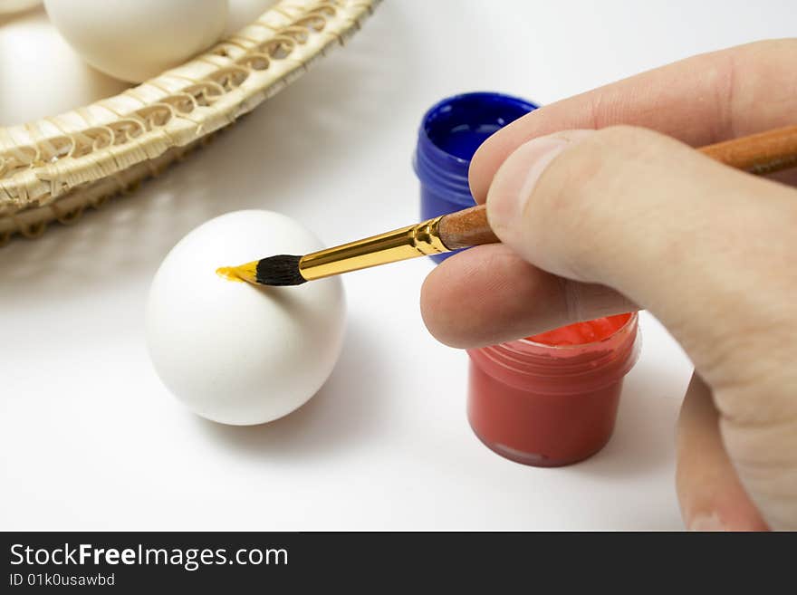 Eggs and paints, preparation for easter on white