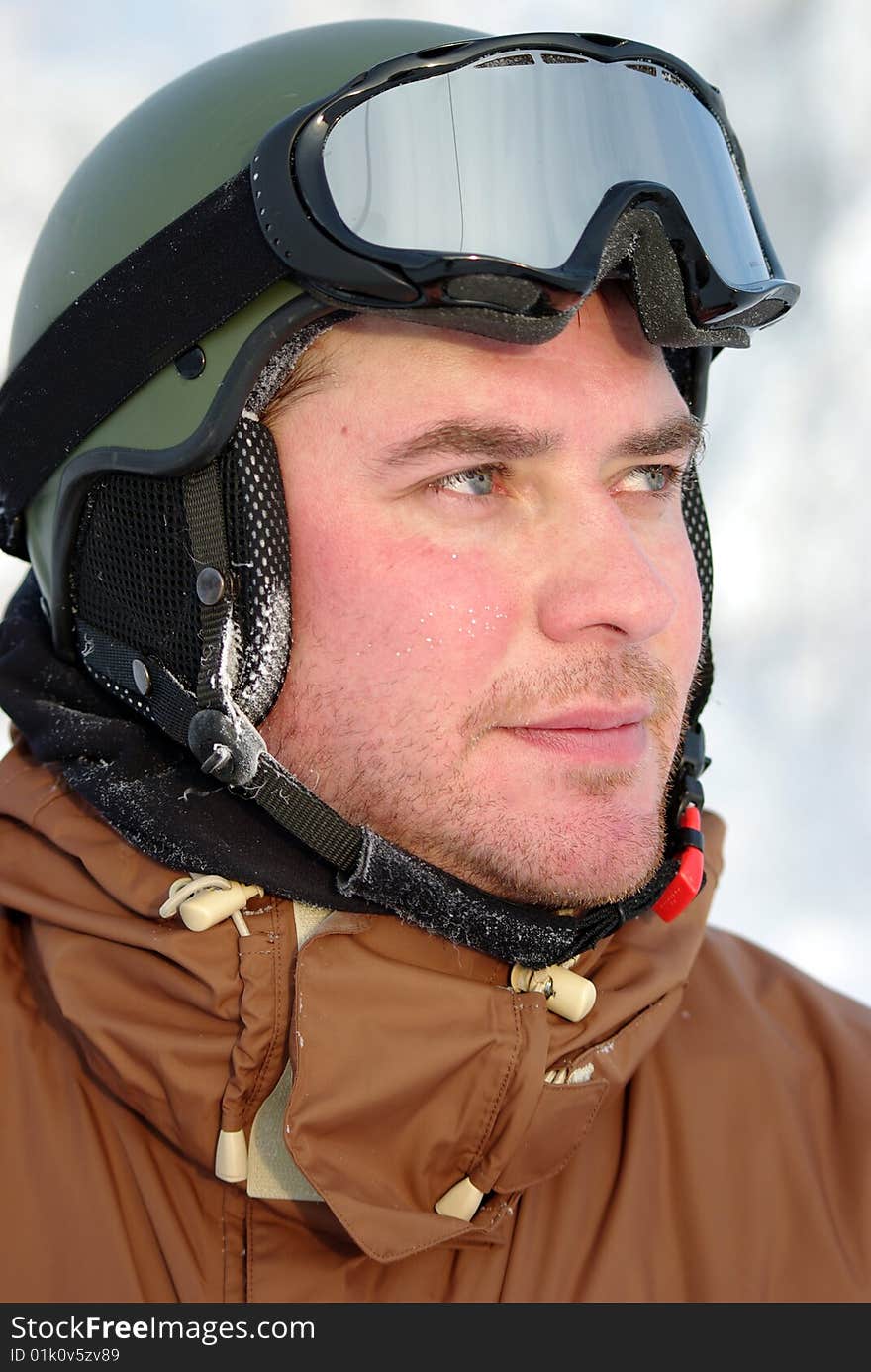 Portrait of a good looking, middle aged snowboarder with protection helmet and snow goggles. Portrait of a good looking, middle aged snowboarder with protection helmet and snow goggles.