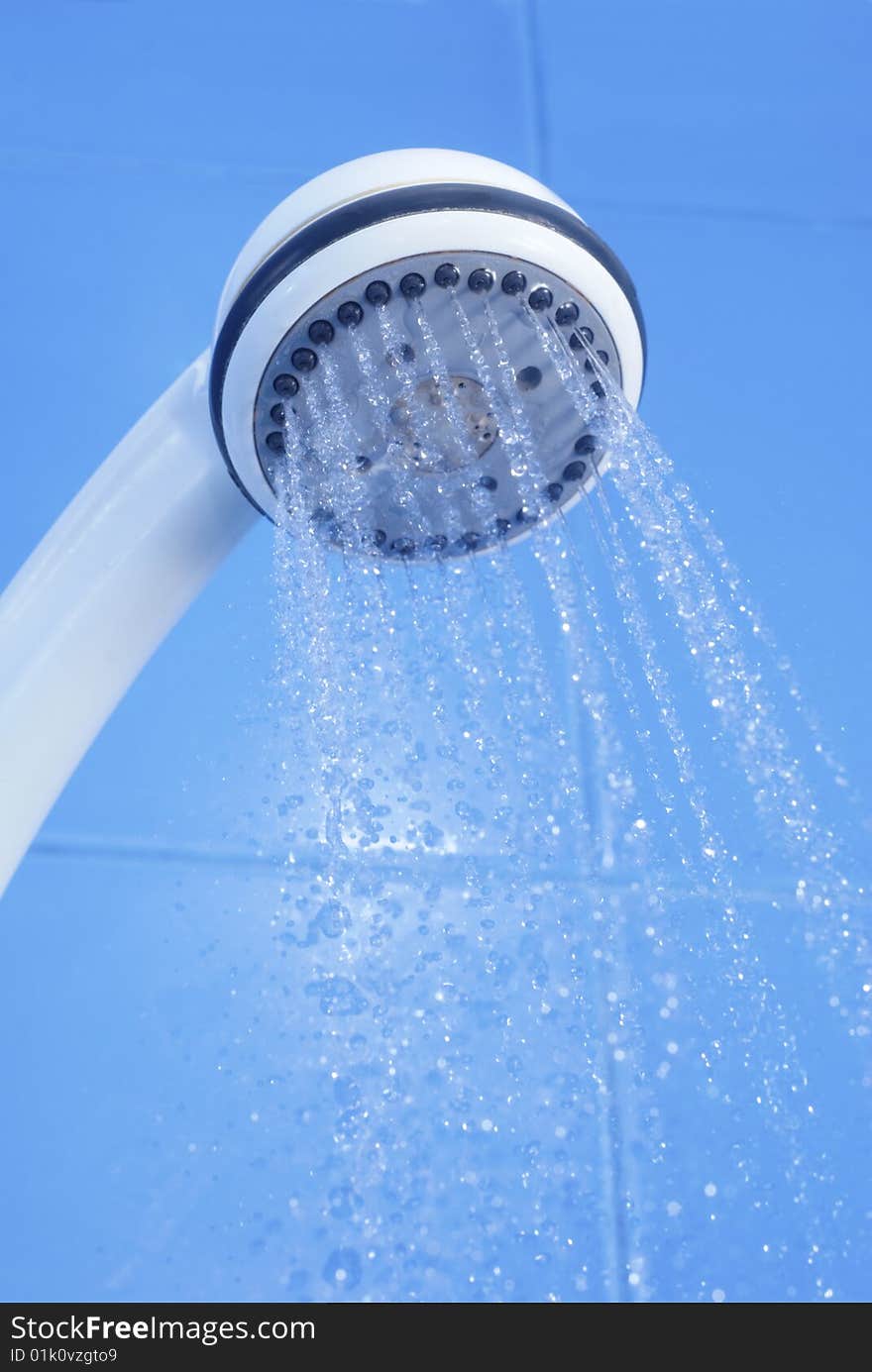 Flozen drops of water from white shower on blue tiled background. Flozen drops of water from white shower on blue tiled background