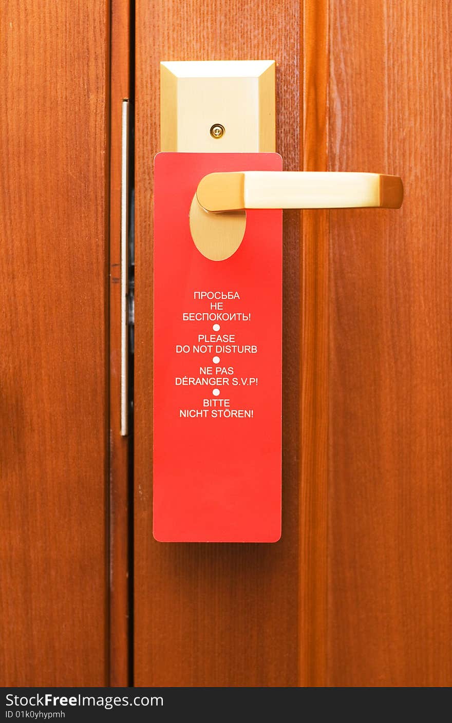 Doorknob with three language notice. Doorknob with three language notice