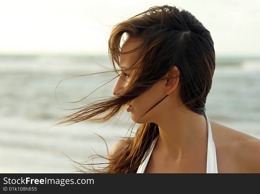 Portrait of woman on the beach by sunset