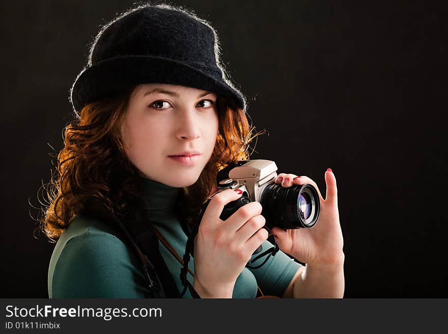 Girl holding a photo on black background. Girl holding a photo on black background