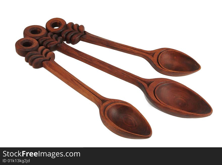 Three greater wooden spoons on a white background