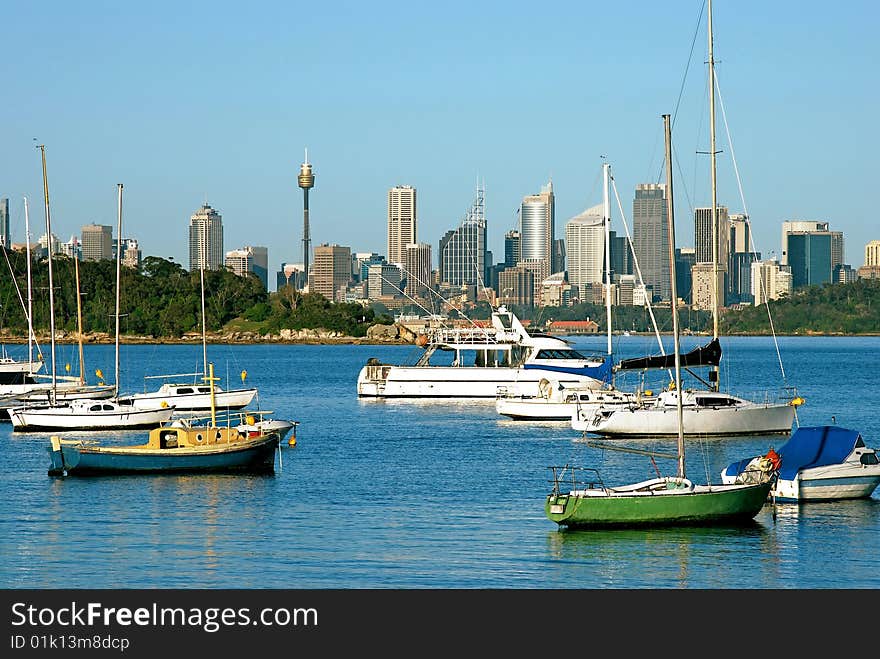 A view down Sydney harbor with yachts lit by dawn light. A view down Sydney harbor with yachts lit by dawn light