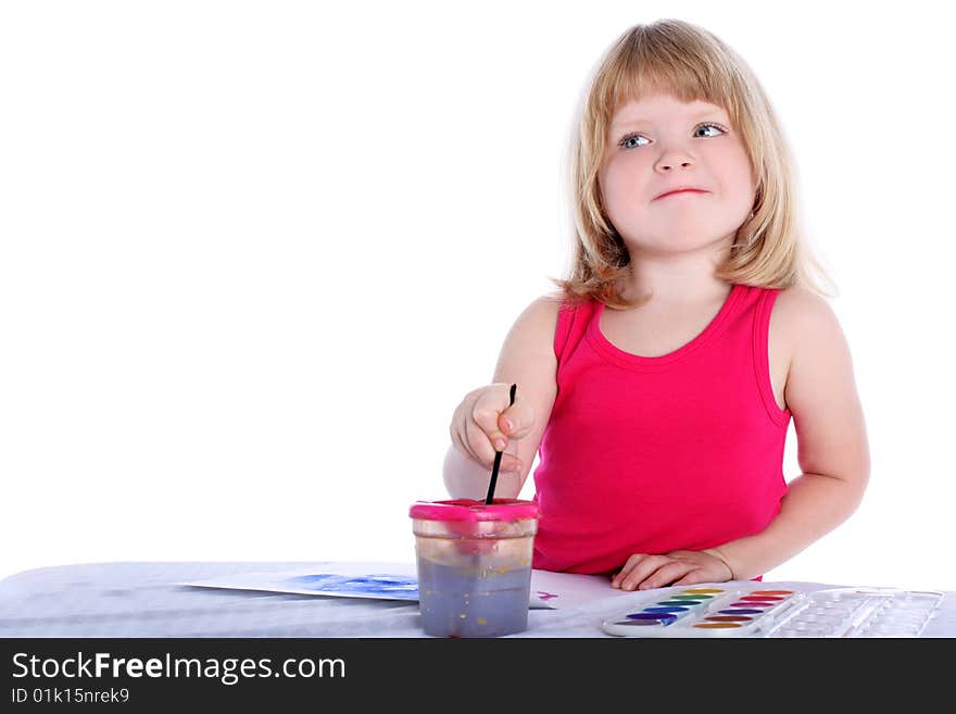 Girl with paint beside table isolated on white