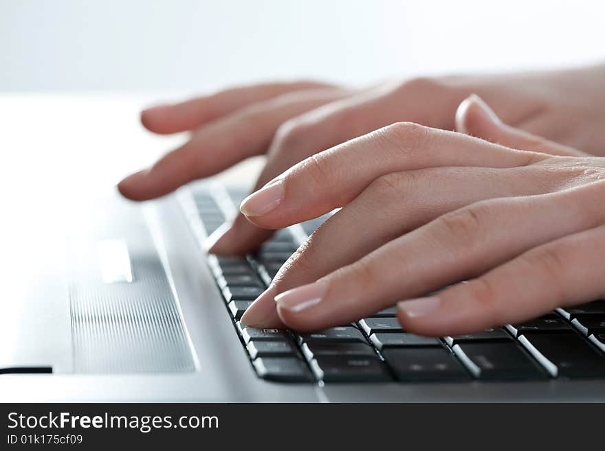 Close-up of female fingers typing a business document on the laptop. Close-up of female fingers typing a business document on the laptop