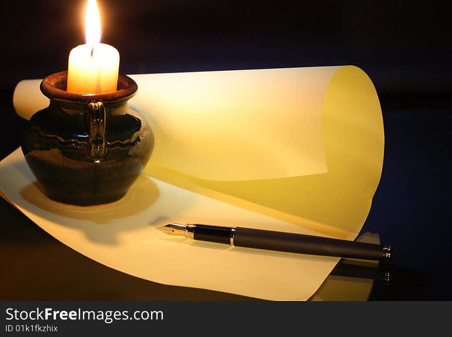 Still-life with candle fountain pen sheet of paper on dark background. Still-life with candle fountain pen sheet of paper on dark background