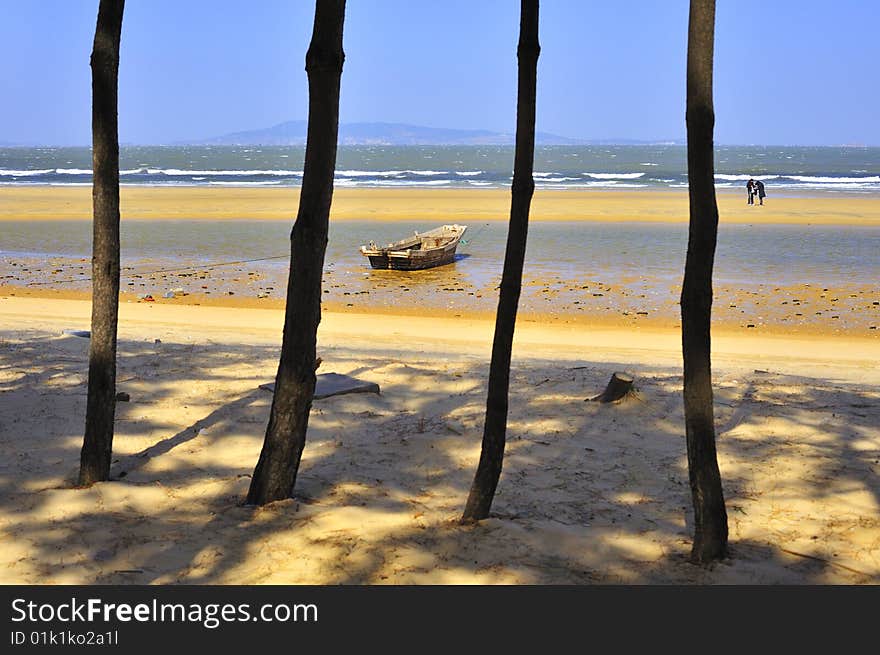 4 trees in seashore, distant place islands and a pair of lover in sand beach.