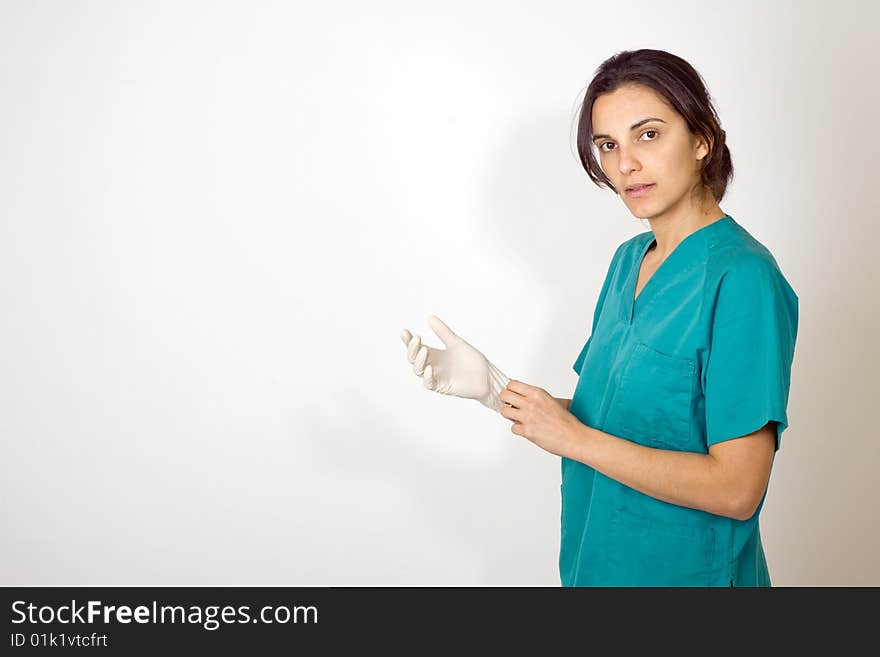 Young nurse stanging before white background