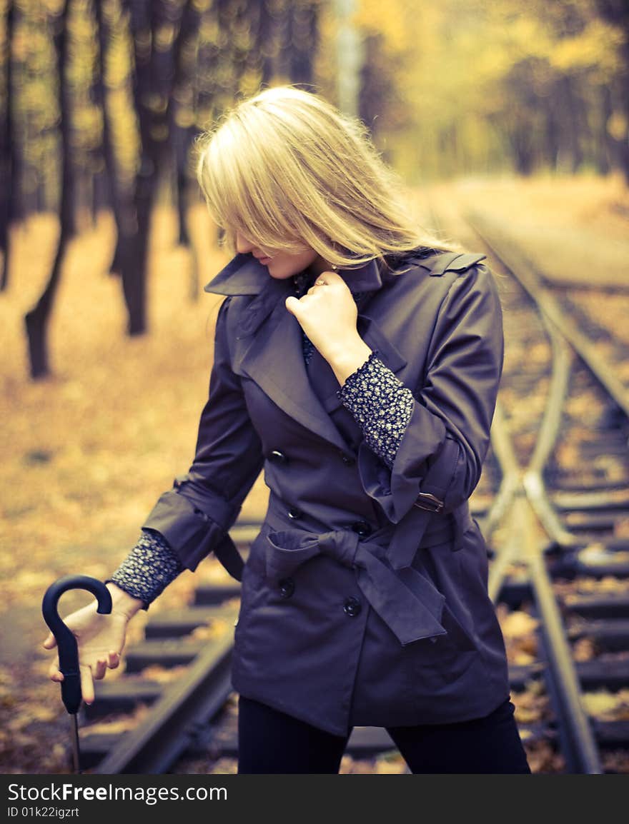 Beautiful woman with blonde long hair at autumn park. Beautiful woman with blonde long hair at autumn park.