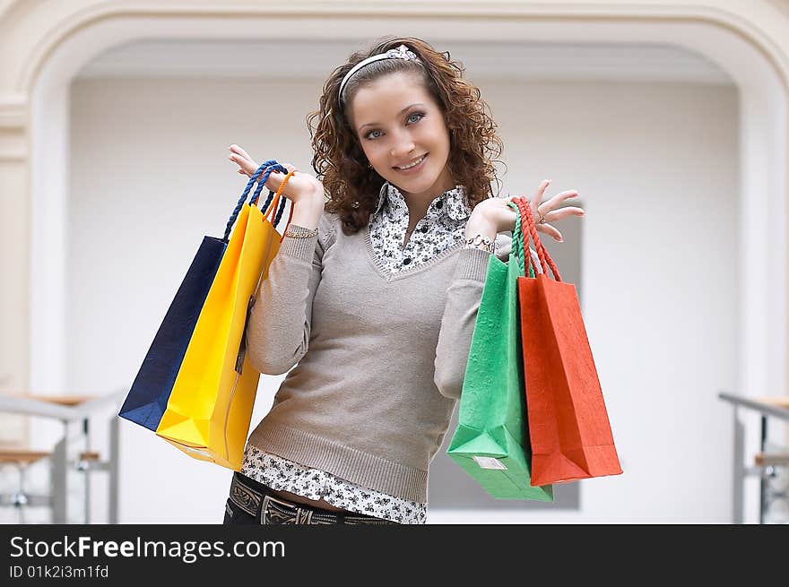 Young girl with colored bags