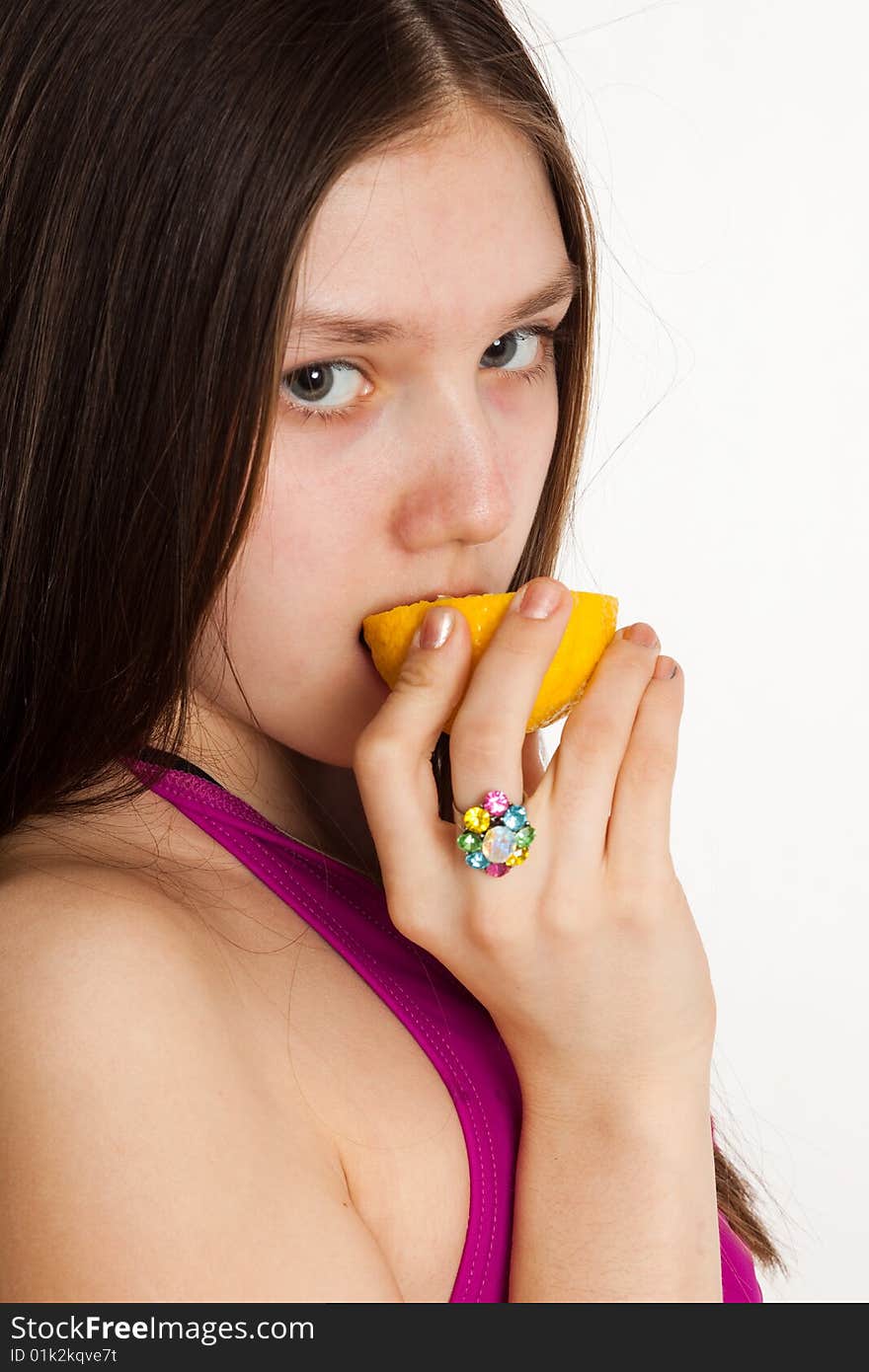 Long hair teen in bikini with piece of lemon. Long hair teen in bikini with piece of lemon