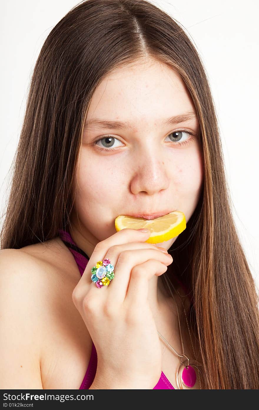 Long hair teen in bikini with piece of lemon. Long hair teen in bikini with piece of lemon